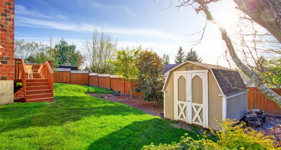 Fenced backyard with storage shed in Joliet